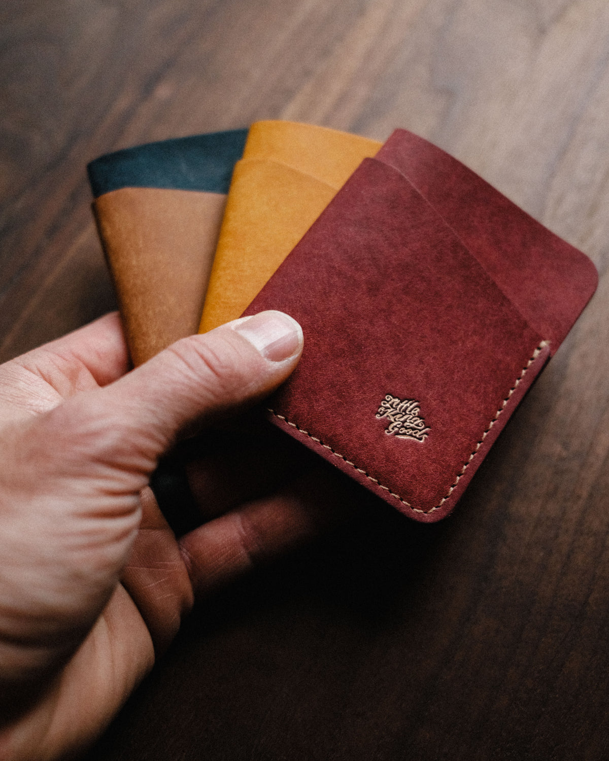 Fold Wallets in Pueblo leather colours held in hand